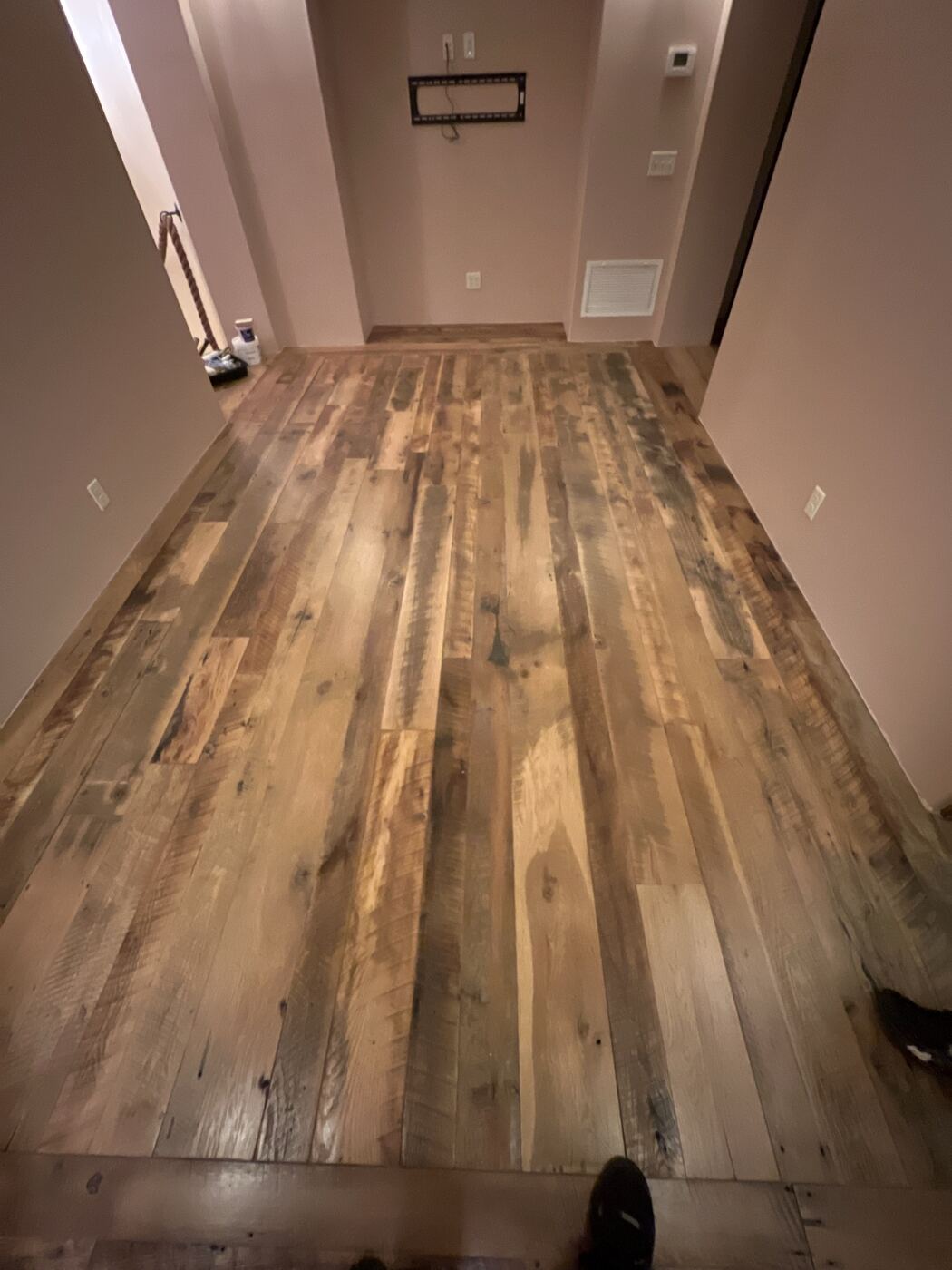 Hallway with hardwood flooring carefully protected and taped off during a painting job
