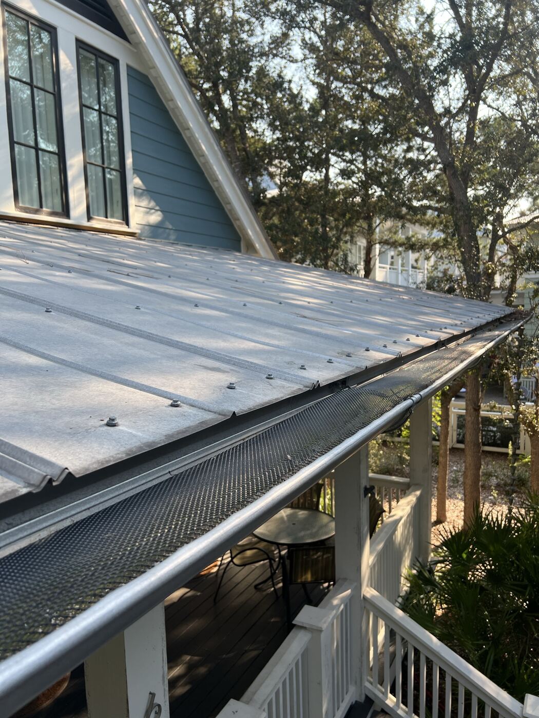 Clean gutter with guard installed, debris-free, after property management service
