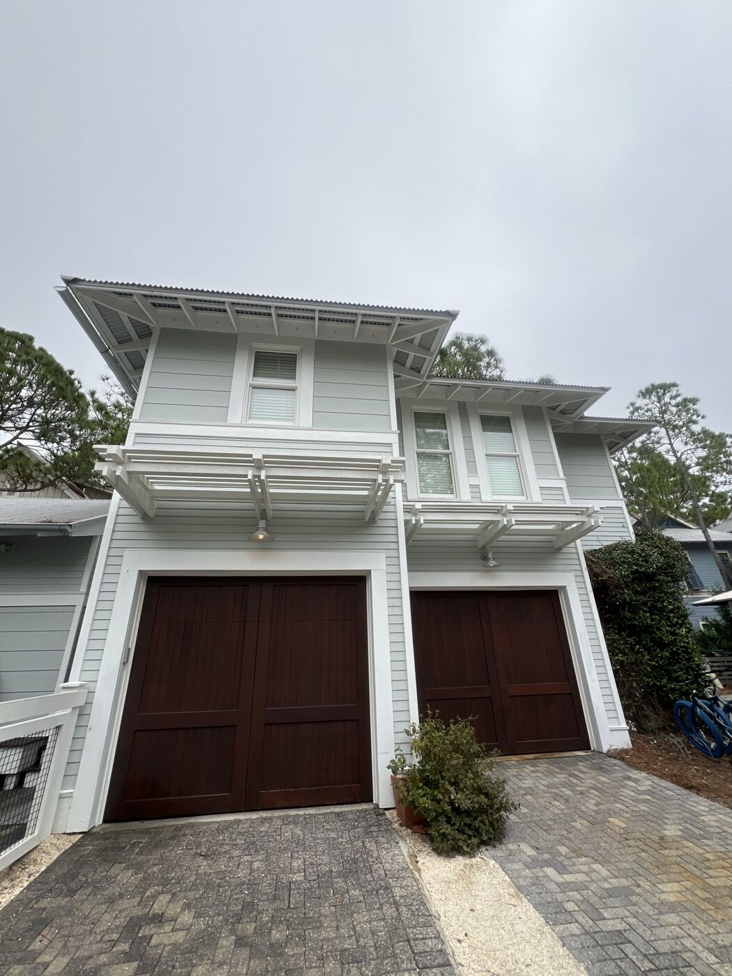 Coastal home exterior after soft washing, siding restored to a bright, clean finish