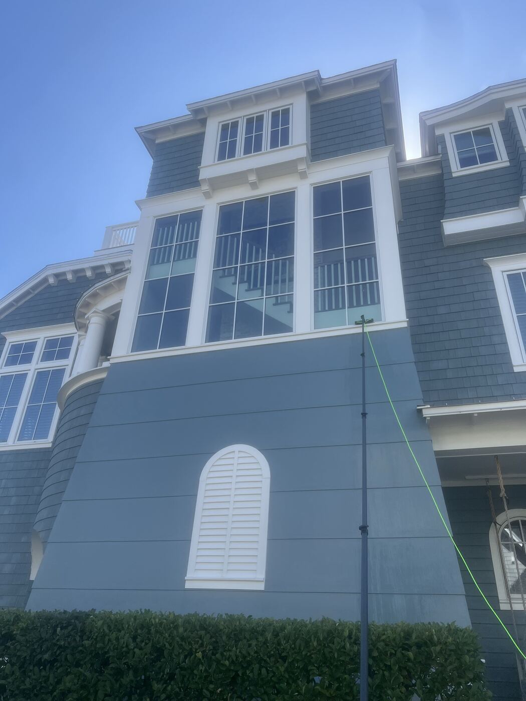 Streak-free floor-to-ceiling windows on a coastal home after window cleaning